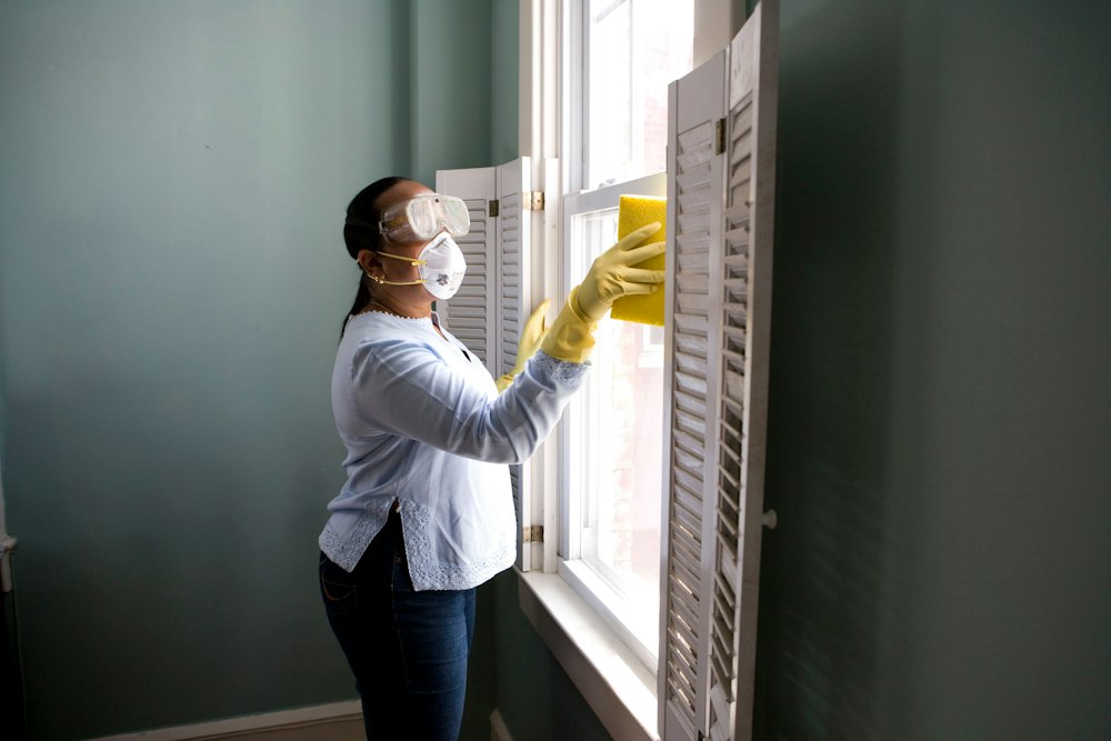 Homeowner preparing and cleaning a house before deciding to repair or sell as-is